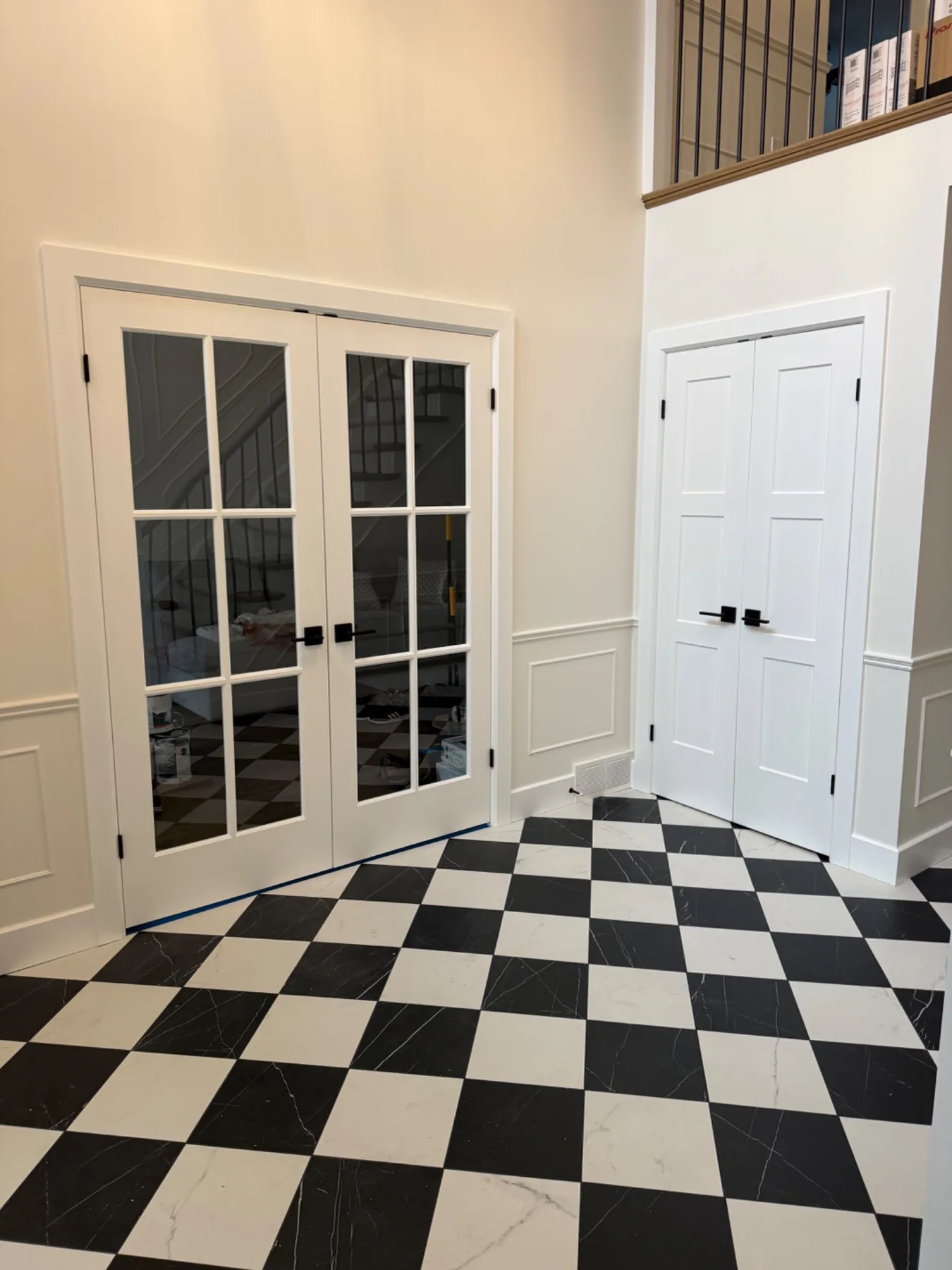 Black and white tiled foyer with custom trim