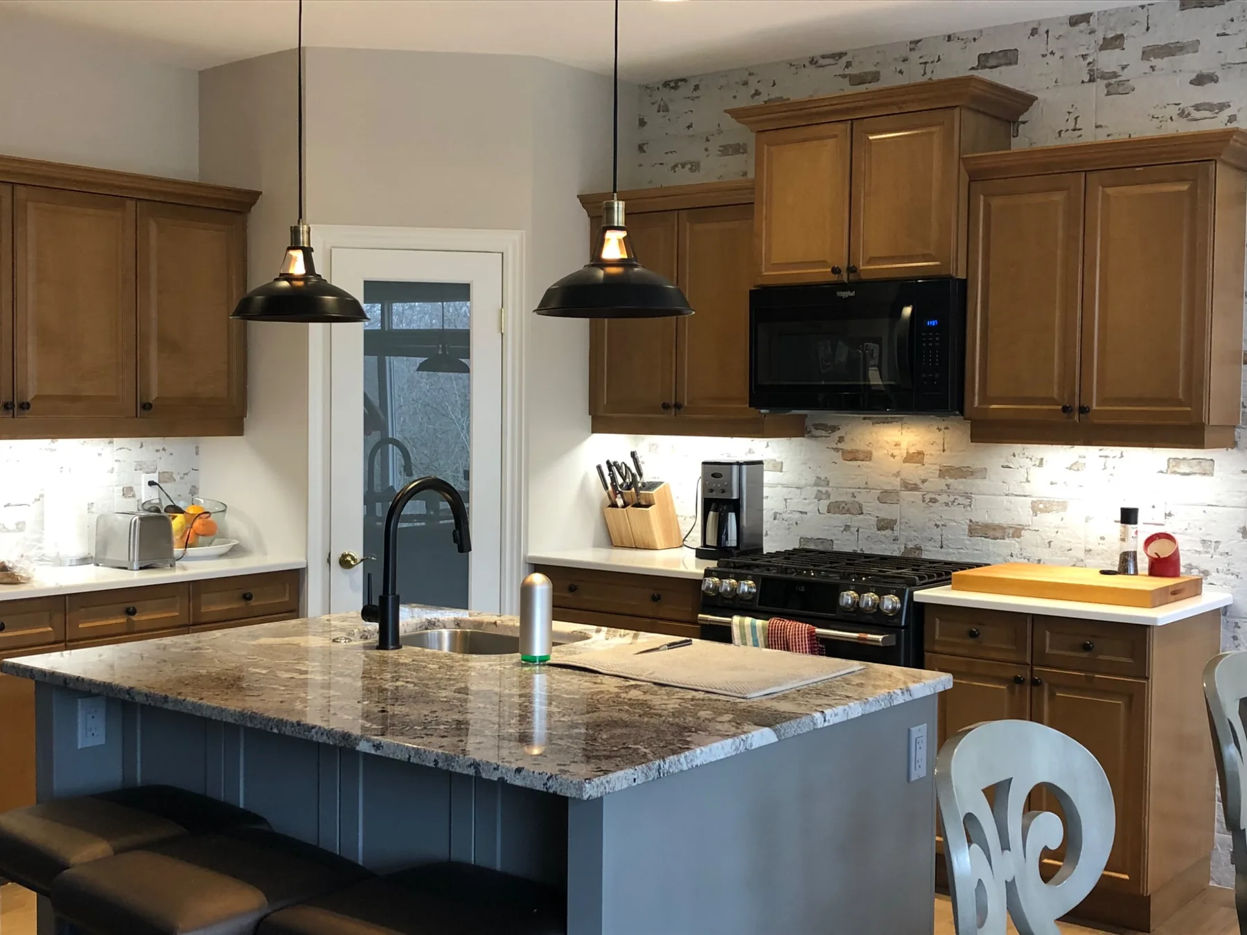 Warm wood kitchen with brick-look feature wall